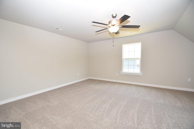 interior space with lofted ceiling, carpet flooring, and ceiling fan