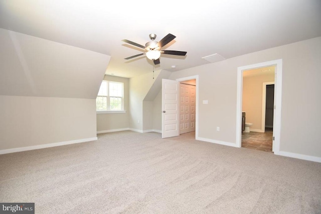 additional living space featuring lofted ceiling, light colored carpet, and ceiling fan