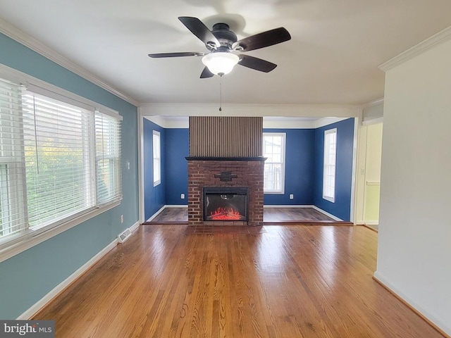 unfurnished living room featuring a fireplace, hardwood / wood-style flooring, ceiling fan, and crown molding