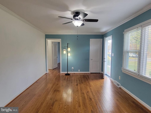 spare room featuring hardwood / wood-style floors, ceiling fan, and crown molding