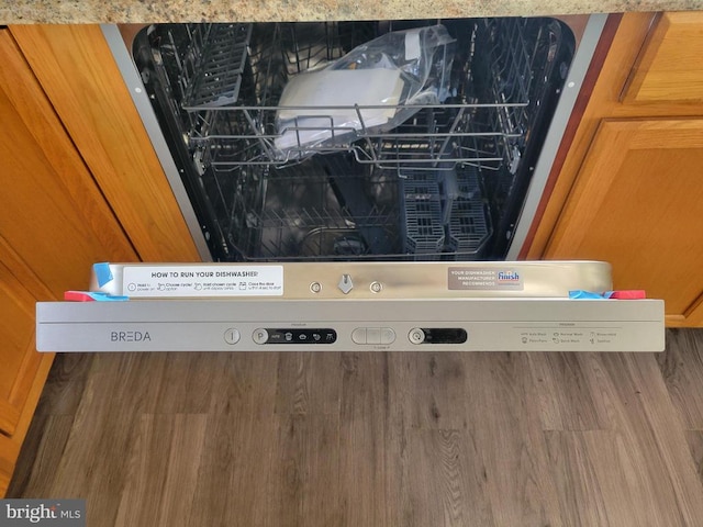 interior details with dishwasher and hardwood / wood-style flooring