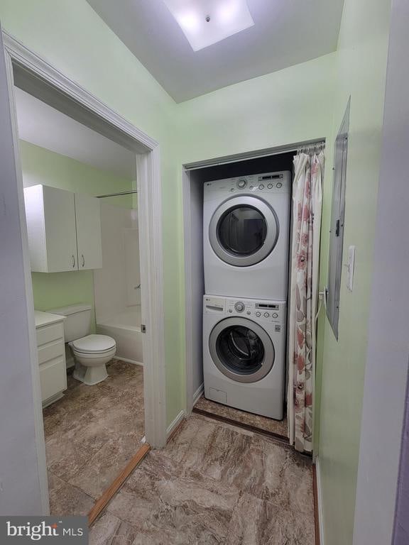 laundry room with stacked washer / dryer