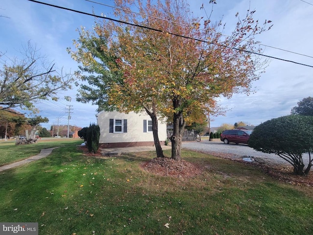 view of property exterior featuring a lawn