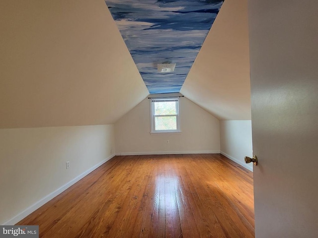 bonus room featuring vaulted ceiling and light hardwood / wood-style floors