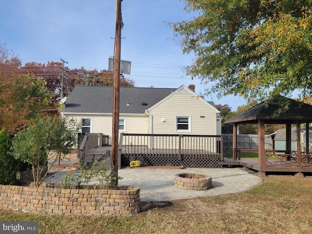 back of property featuring an outdoor fire pit, a gazebo, and a wooden deck