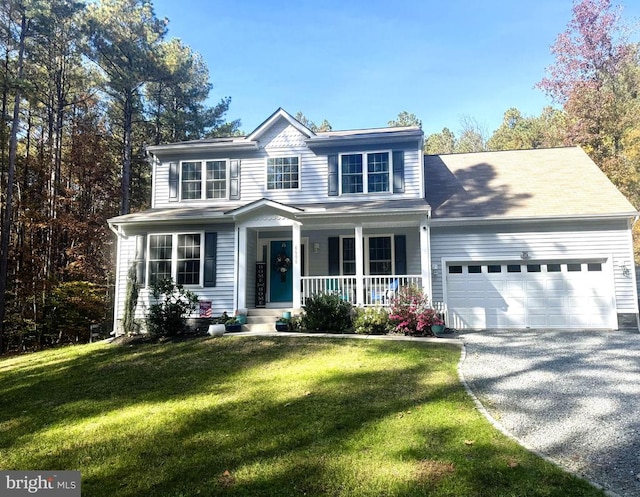 view of front of home featuring a porch, a front lawn, and a garage