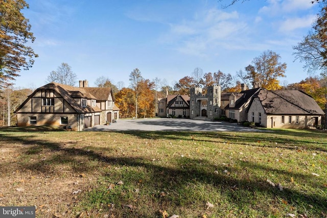 exterior space featuring a garage and a front lawn