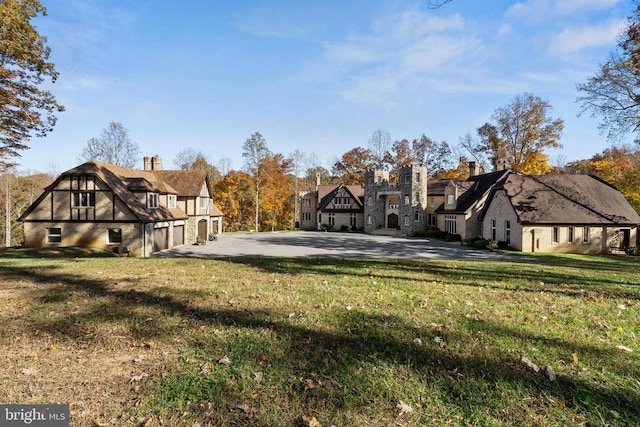 exterior space with a garage and a front lawn