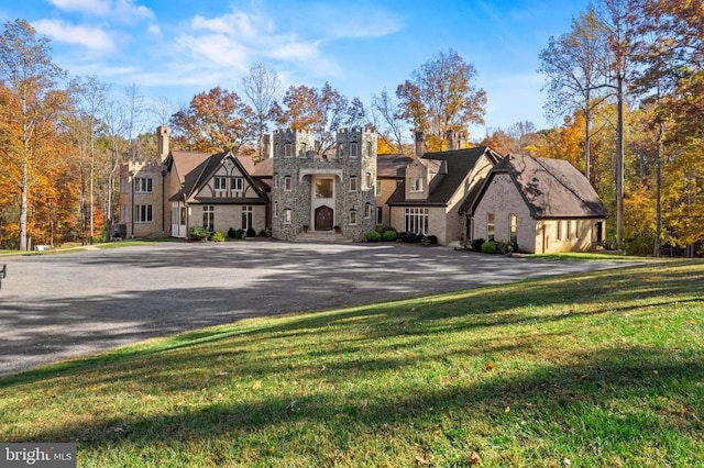 tudor home featuring a front yard