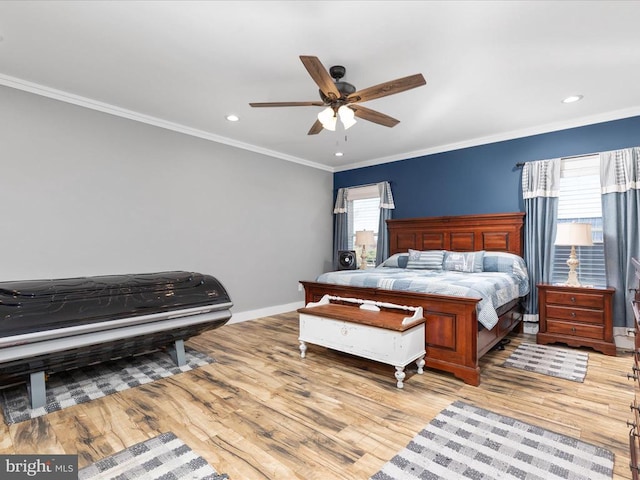 bedroom featuring ceiling fan, multiple windows, light hardwood / wood-style flooring, and crown molding