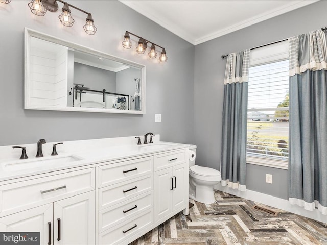 bathroom featuring toilet, vanity, parquet floors, and crown molding