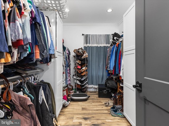 spacious closet featuring light hardwood / wood-style floors