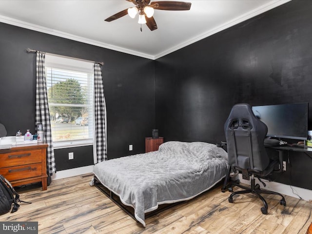 bedroom with crown molding, ceiling fan, and light hardwood / wood-style flooring