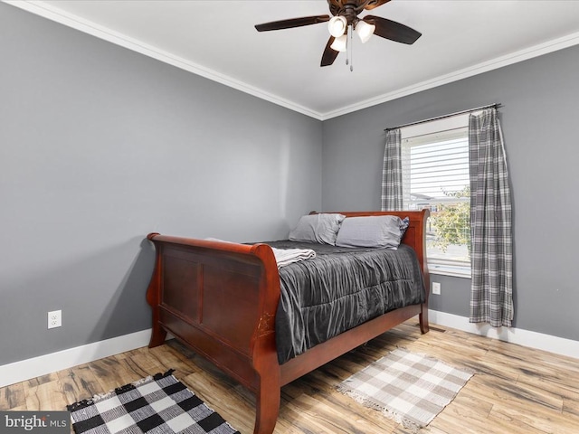 bedroom with hardwood / wood-style floors, ceiling fan, and crown molding