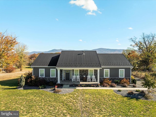 back of property featuring a porch, a lawn, and a mountain view