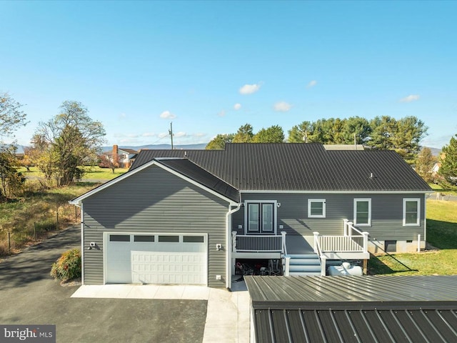 view of front facade featuring a deck and a garage