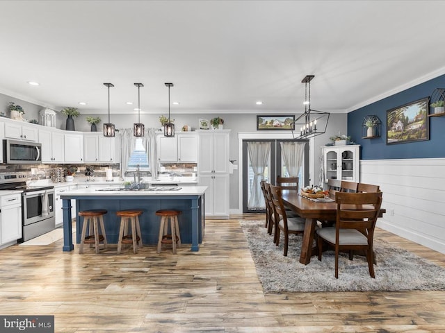 kitchen with plenty of natural light, decorative light fixtures, and appliances with stainless steel finishes