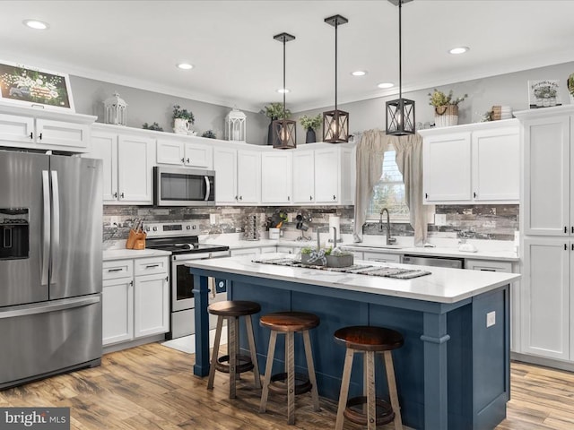 kitchen featuring a kitchen island, white cabinets, and stainless steel appliances