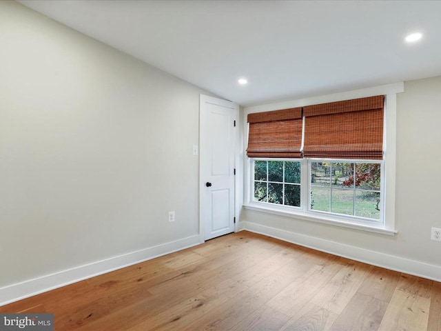 spare room featuring light hardwood / wood-style flooring