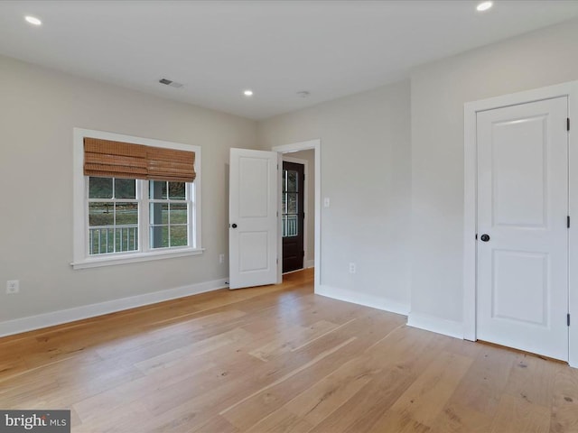 spare room with light hardwood / wood-style flooring