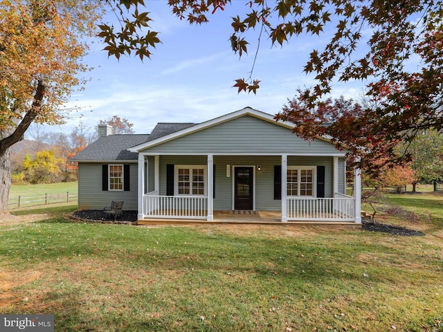 view of front of property with a porch and a front lawn