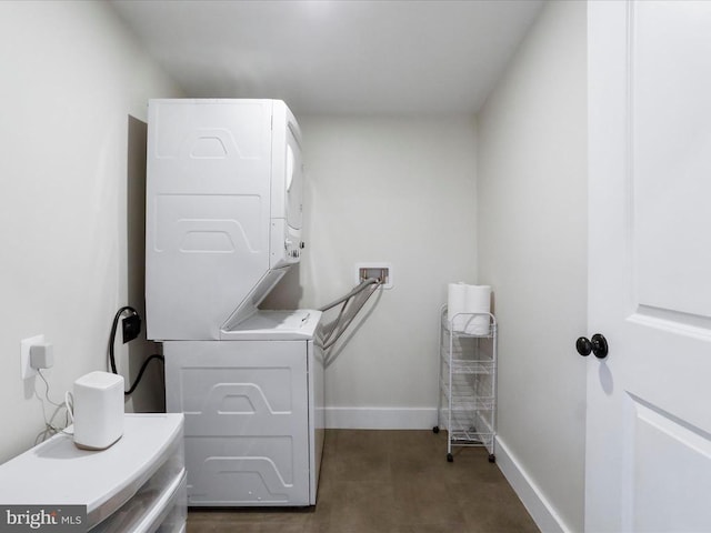 clothes washing area featuring stacked washer / dryer