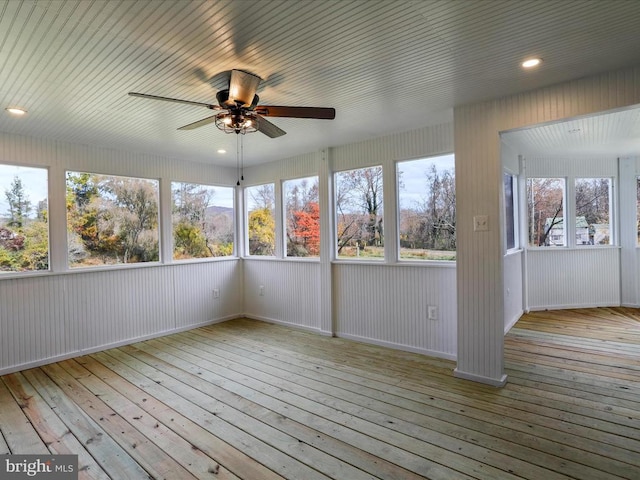 unfurnished sunroom with plenty of natural light and ceiling fan