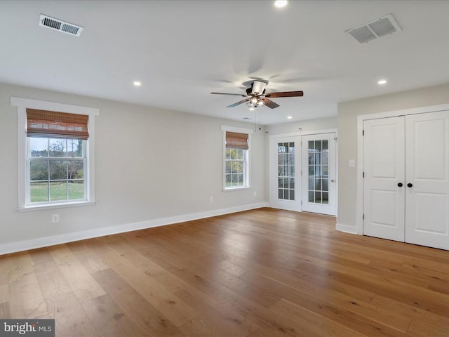 spare room with french doors, hardwood / wood-style flooring, and ceiling fan