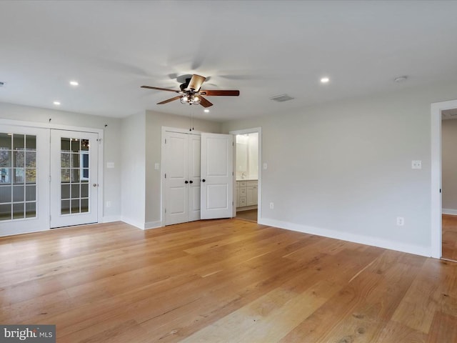 empty room featuring ceiling fan and light hardwood / wood-style flooring