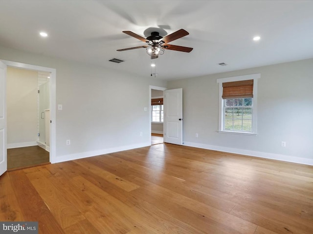 empty room with light wood-type flooring and ceiling fan