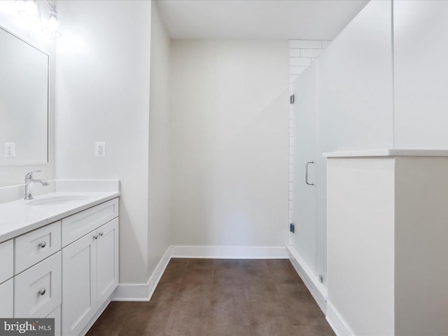 bathroom with walk in shower, vanity, and hardwood / wood-style flooring