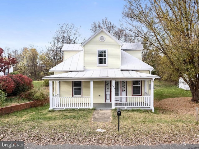 view of front of property with a front yard and a porch