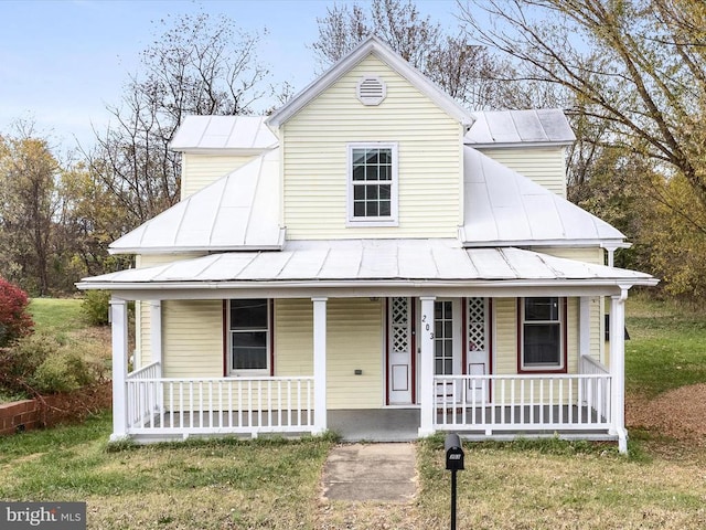 view of front facade with covered porch and a front yard