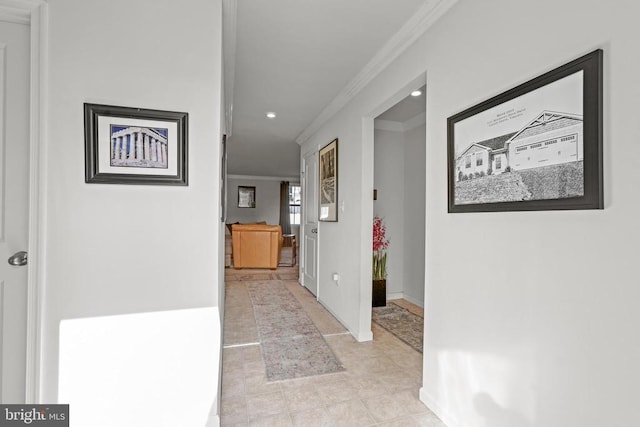 hall featuring light tile patterned flooring and ornamental molding