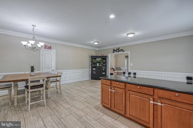 kitchen with crown molding, a chandelier, and decorative light fixtures