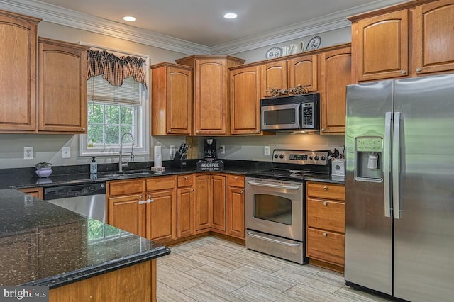 kitchen with dark stone countertops, sink, ornamental molding, and appliances with stainless steel finishes