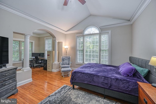 bedroom featuring hardwood / wood-style floors, ceiling fan, vaulted ceiling, and multiple windows