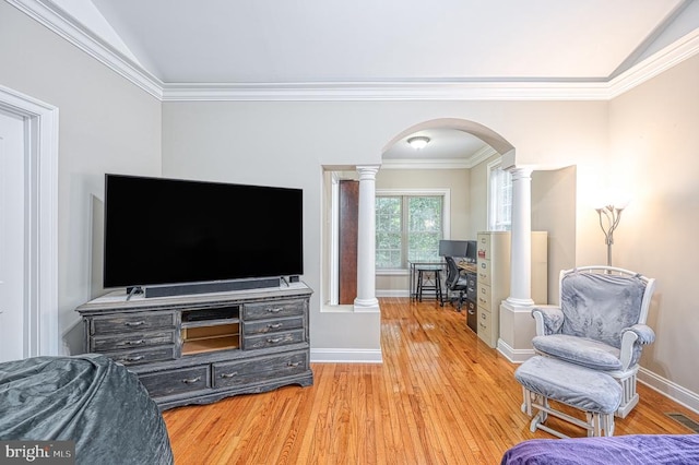 living room featuring hardwood / wood-style floors, lofted ceiling, and crown molding