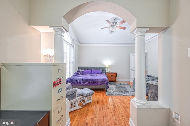 bedroom with decorative columns, ornamental molding, and light hardwood / wood-style flooring