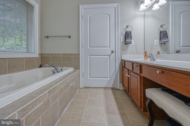 bathroom featuring tile patterned flooring, vanity, and tiled tub