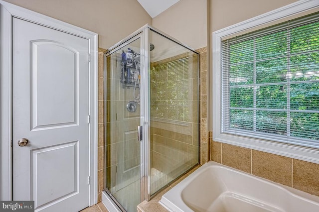 bathroom featuring plus walk in shower and a healthy amount of sunlight