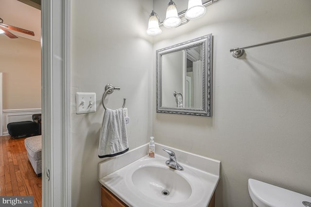 bathroom featuring hardwood / wood-style flooring, vanity, and toilet