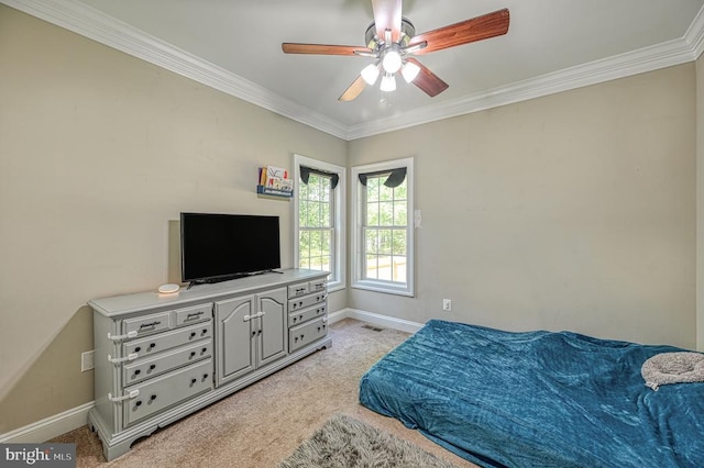 carpeted bedroom with ceiling fan and ornamental molding