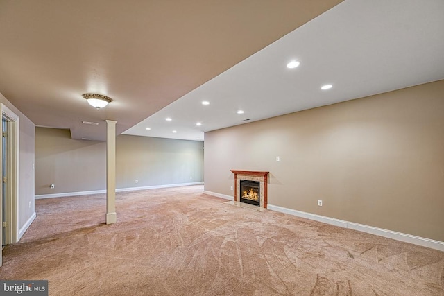 basement with light carpet and a high end fireplace