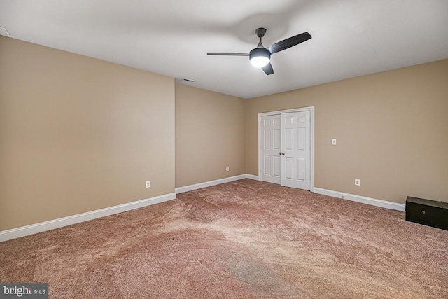 unfurnished bedroom with carpet flooring, ceiling fan, and a closet