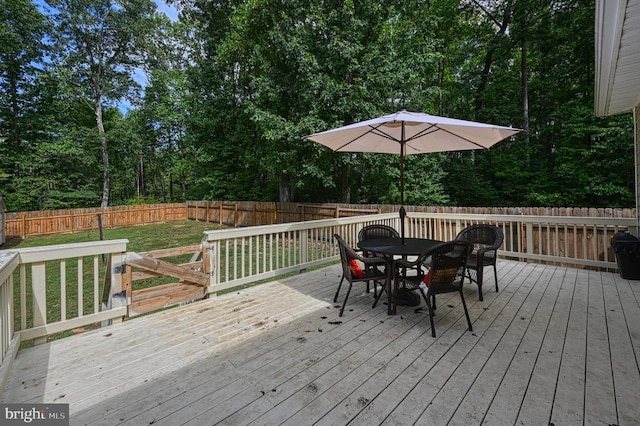 wooden deck with a lawn