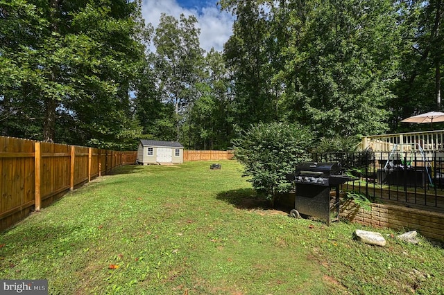 view of yard featuring a shed and a wooden deck