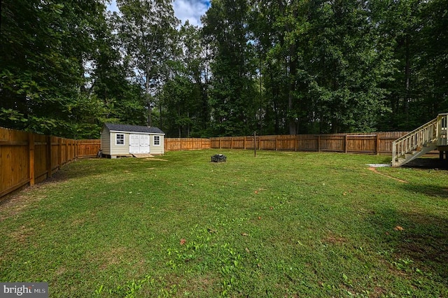 view of yard with a storage unit and an outdoor fire pit