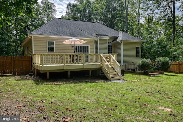 back of house featuring a deck and a yard