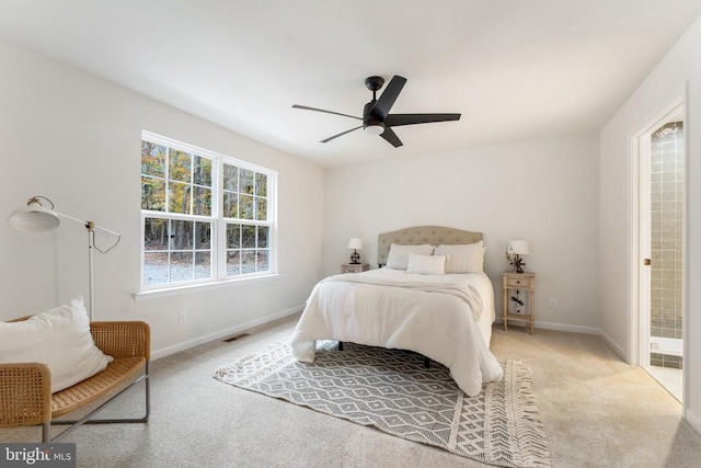 bedroom with ceiling fan, connected bathroom, and light colored carpet